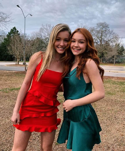 Sadie Stanley taking a picture with her twin sister Sophie.